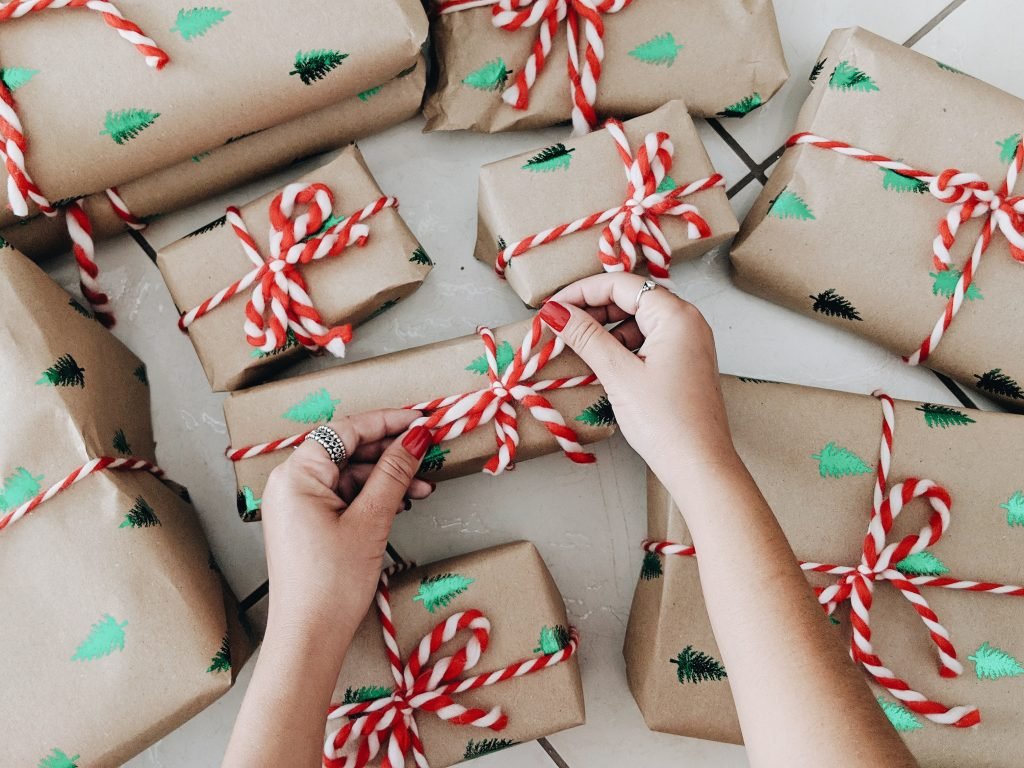 a pair of female hands wrapping presents