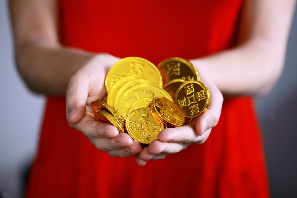 woman holding chocolate coins