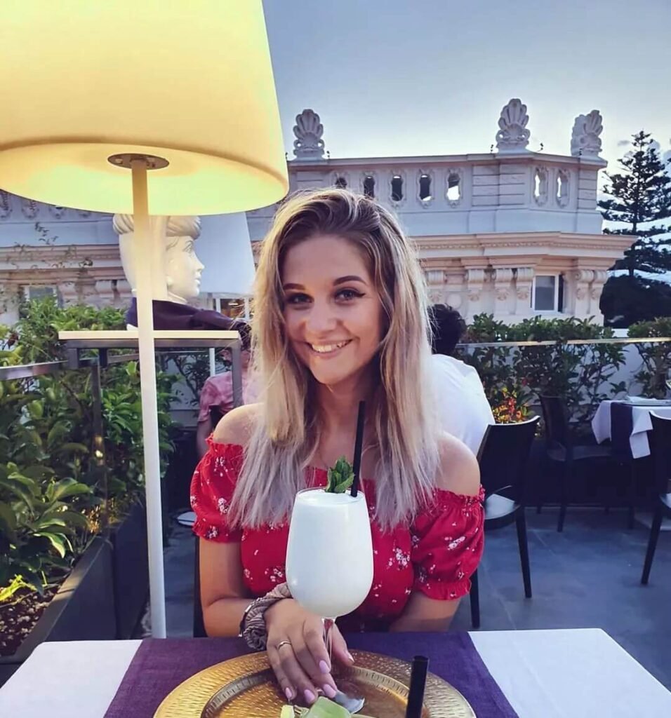 dani drinking a cocktail on one of palermo's rooftop bars