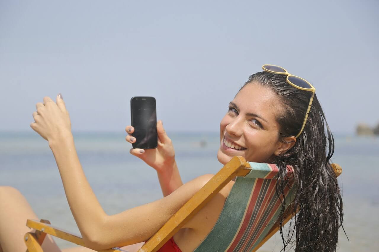 a woman on a sunlounger smiling at the camera