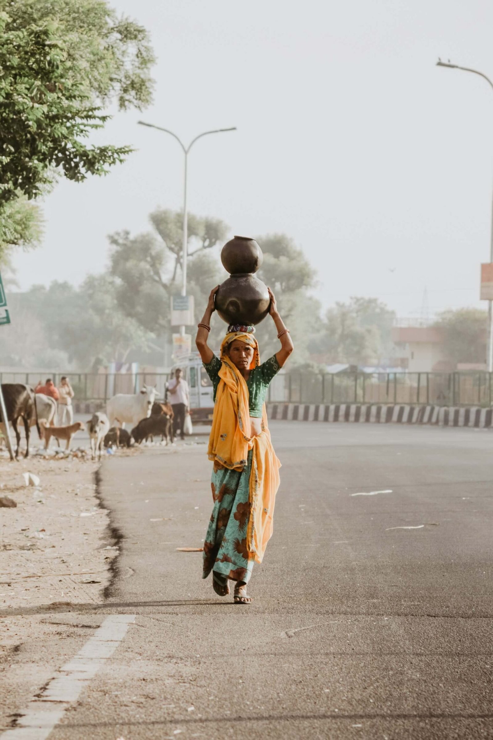 an indian woman carrying water