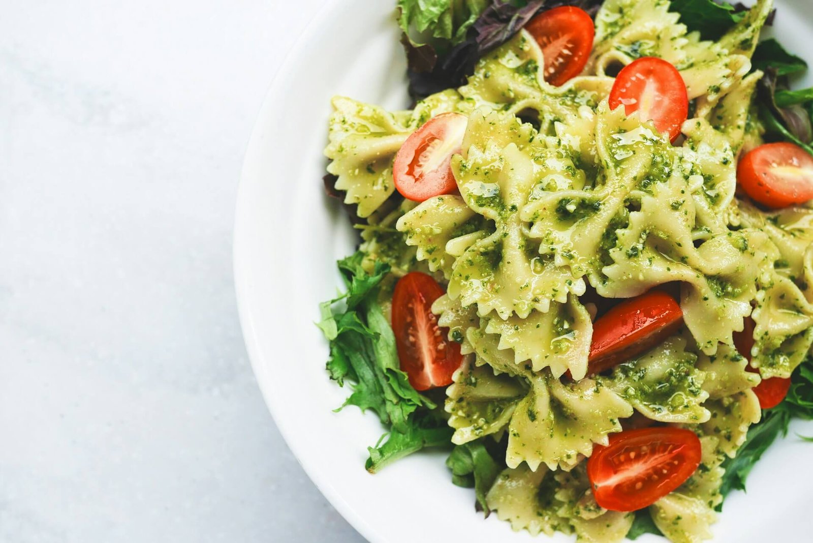 green pesto pasta with cherry tomatoes