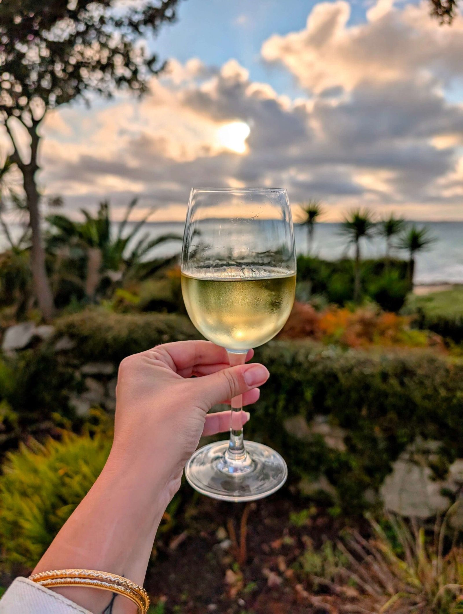 a glass of white wine at sunset on herm island