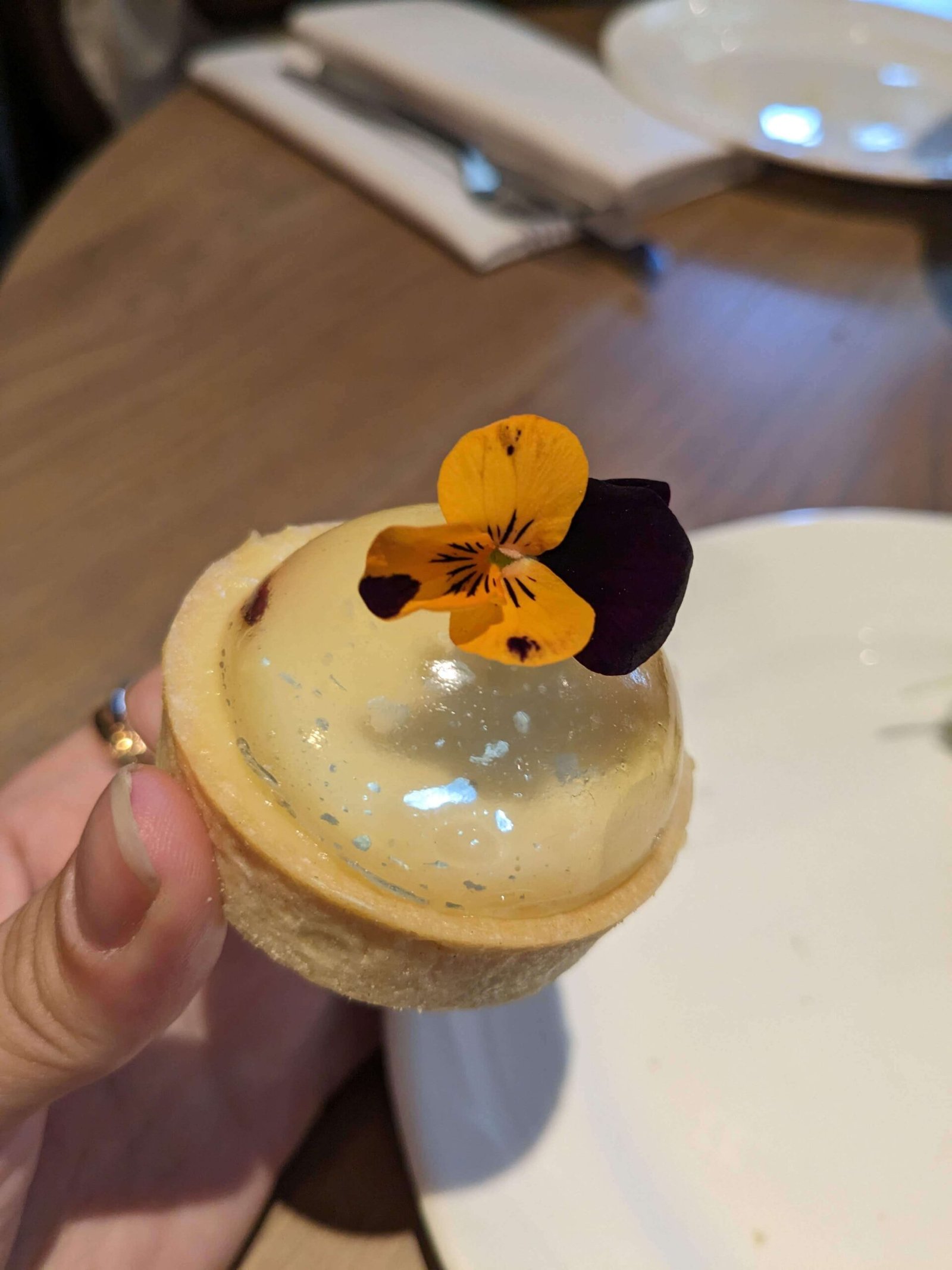 a small cake with flower petals on top