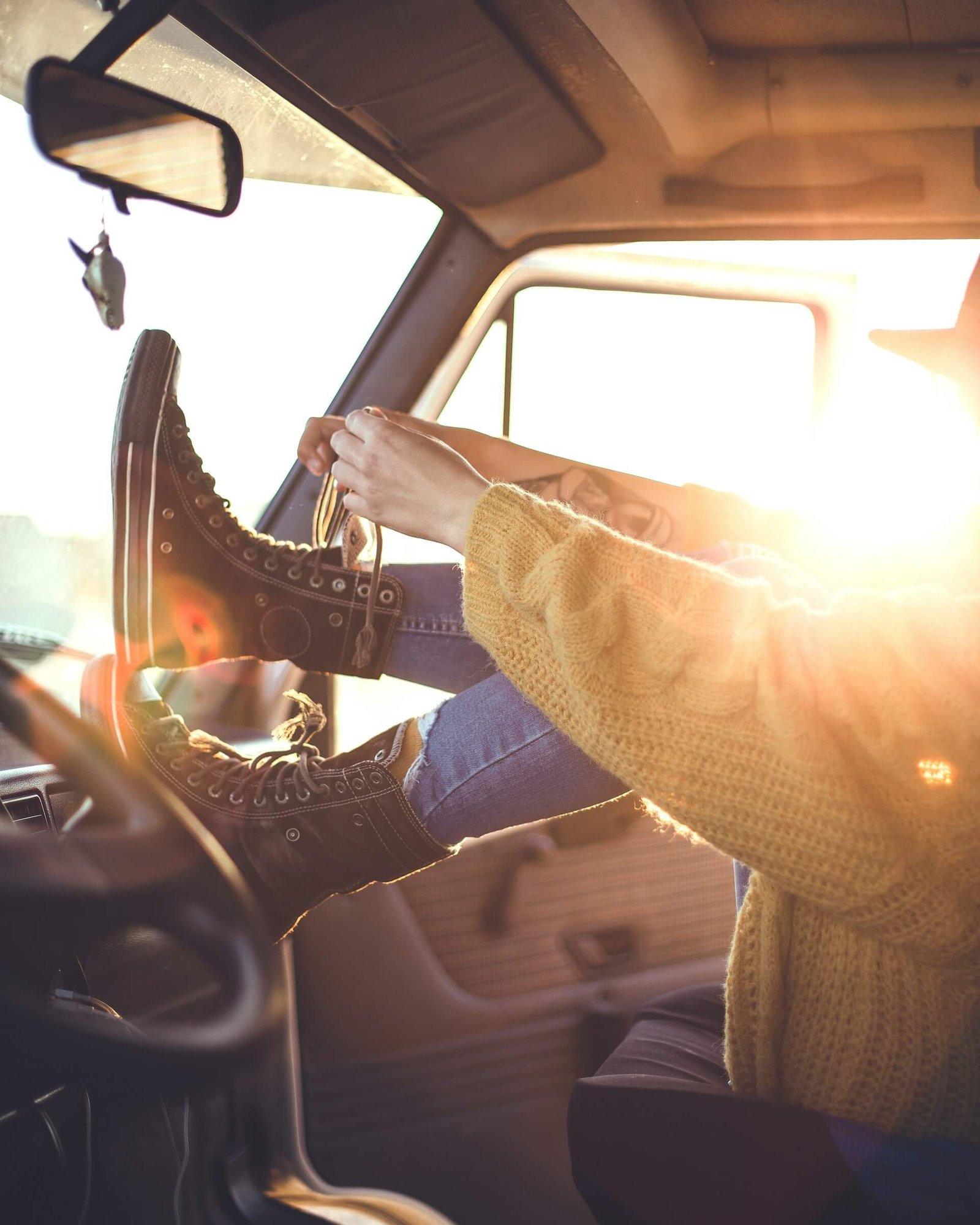 somebody tying their shoelaces in a car 