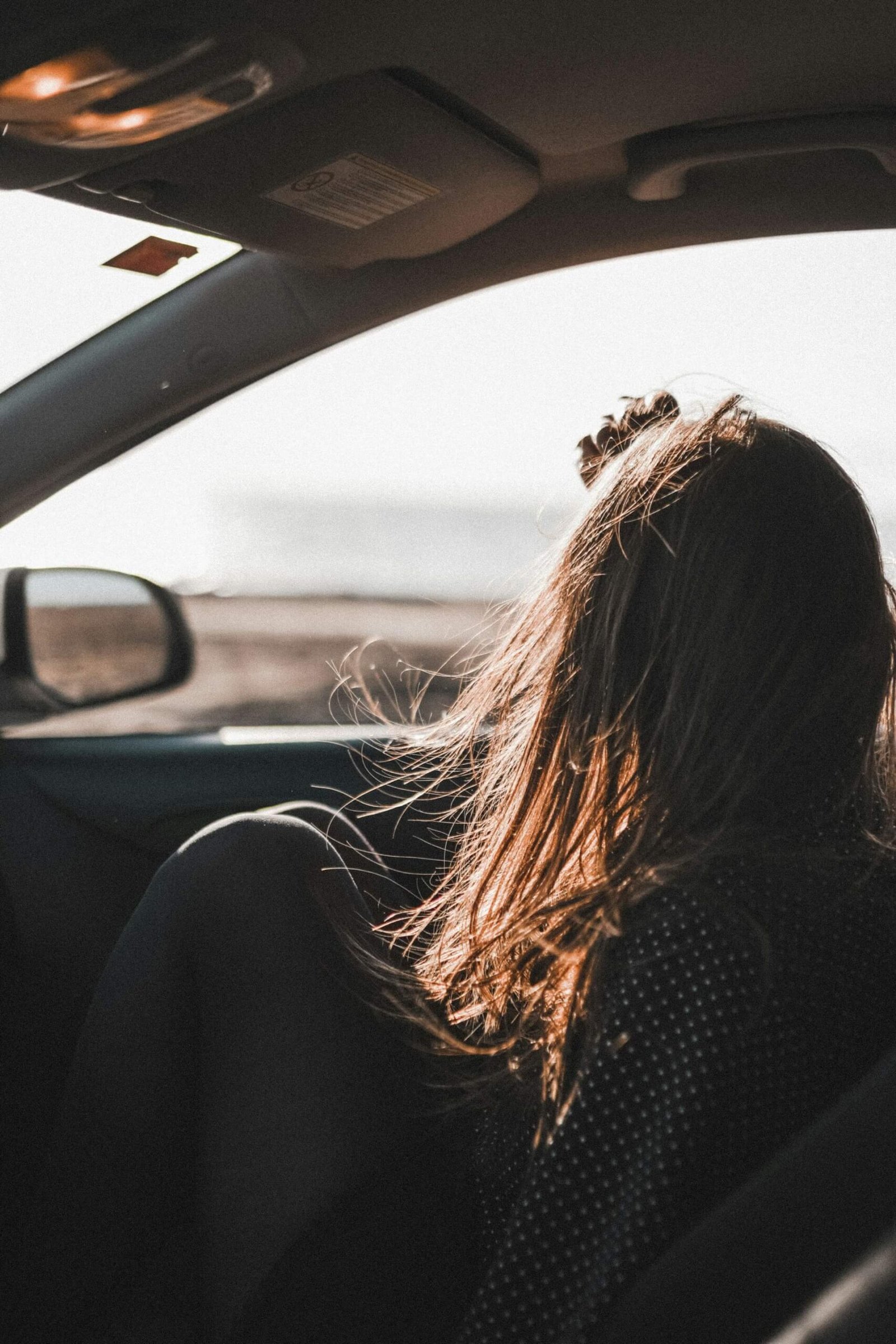 a girl looking out of a car window 