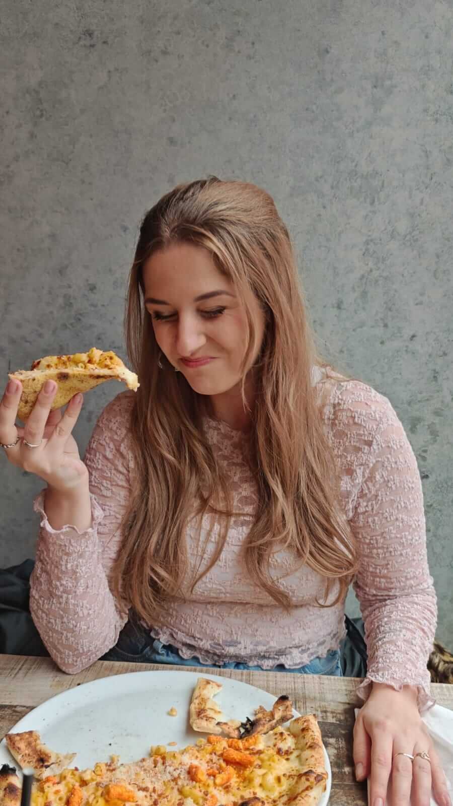 dani eating pizza at pizza punks liverpool