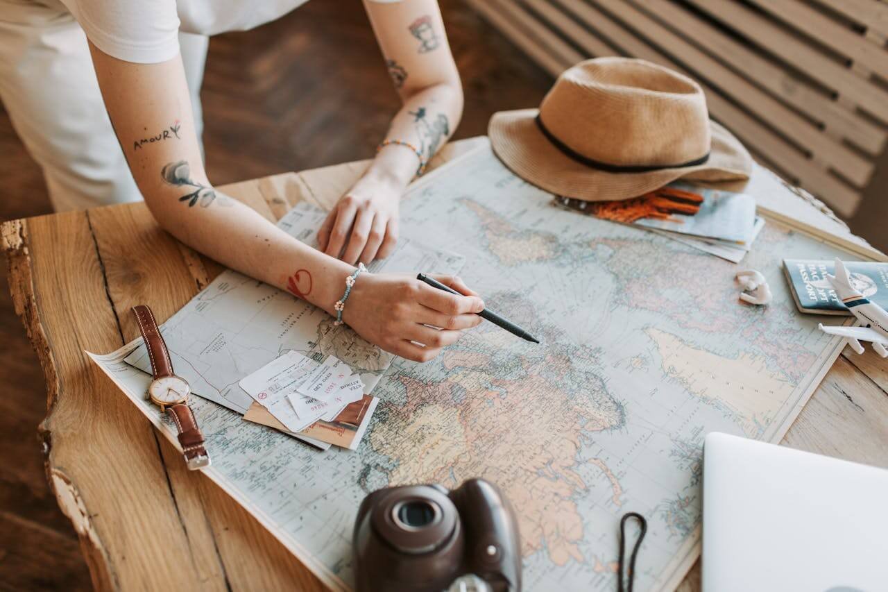 a person planning a trip with a world map