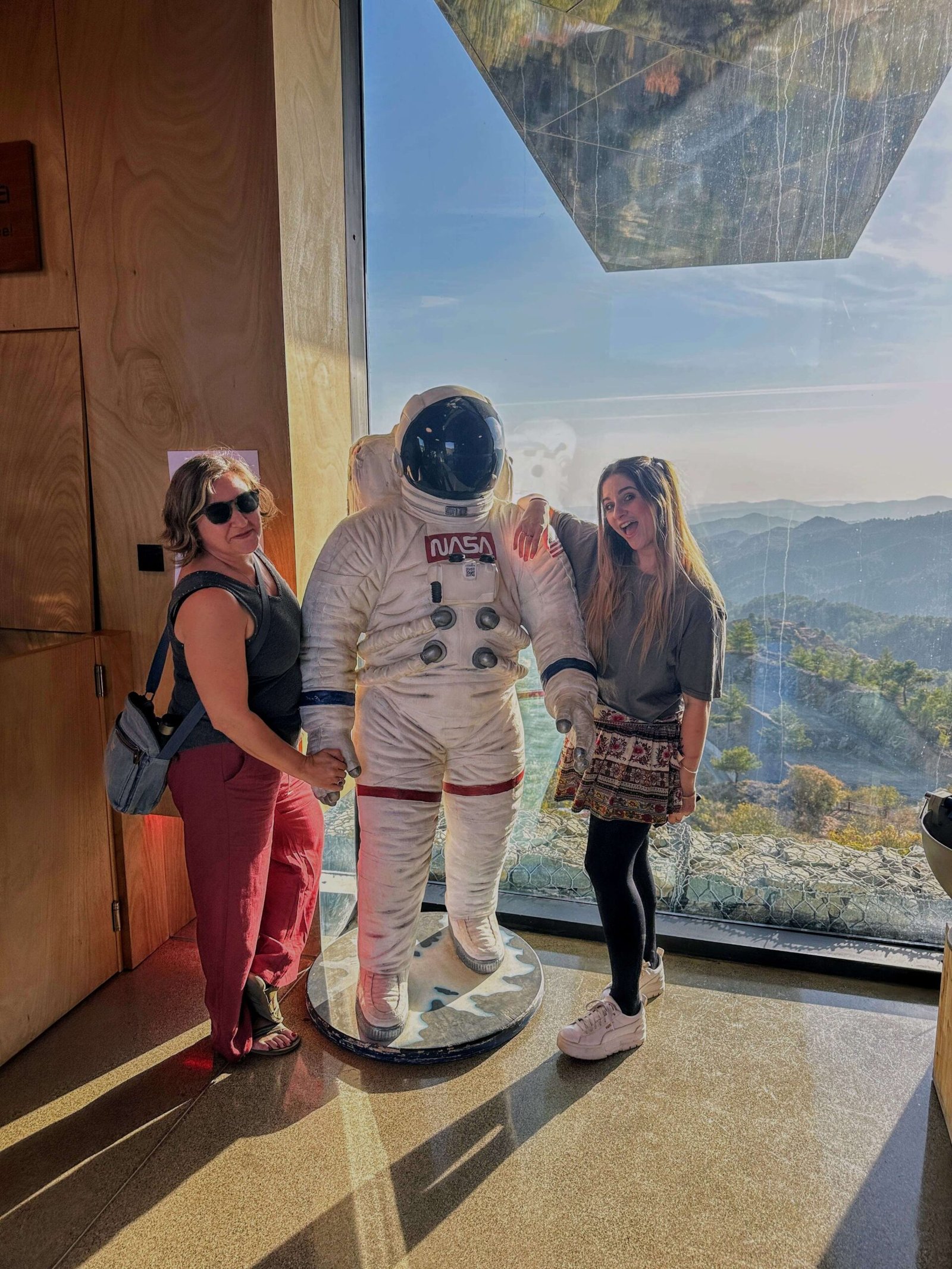 the author and her friend posing with an astronaut at troodos observatory