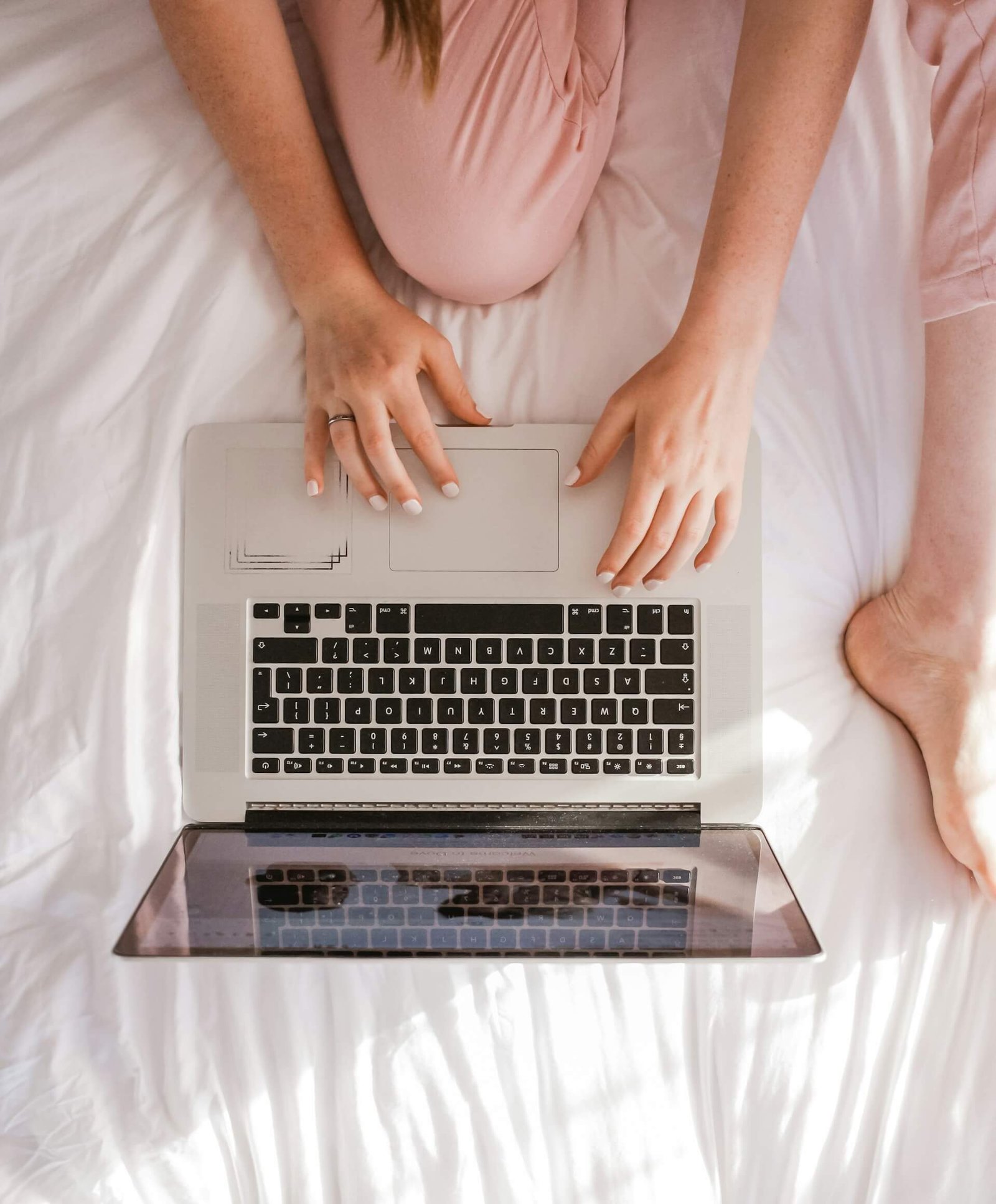 a woman typing on a laptop